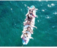 Woman jumping joyfully by an Austrian lake