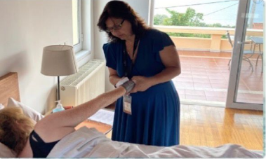 Two women laughing and sharing drinks